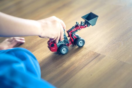 Child Playing Front Loader Toy photo