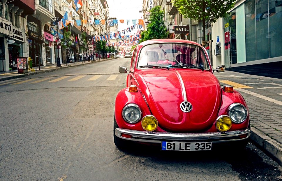 Red Volkswagen Beetle Parked At Road Side Near Pedestrian Lane