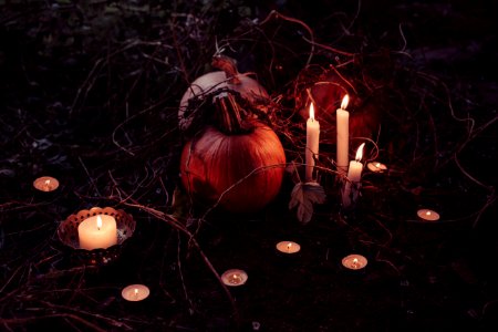 Jack O Lantern Beside Candles Halloween Decor photo