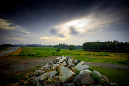 Stratus Clouds Above Green Grass And Beige Stones