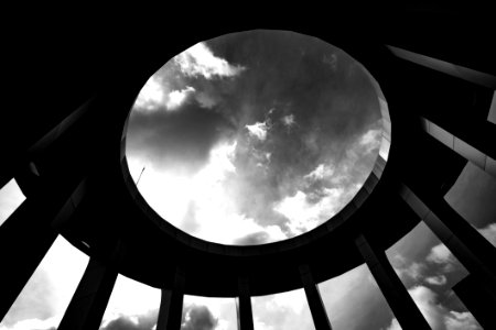 Grayscale Photo Of A Round Building With Hole photo