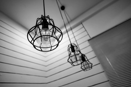 Black Steel Framed Round Pendant Lamp Indoors Near Window Blinds On Grayscale photo