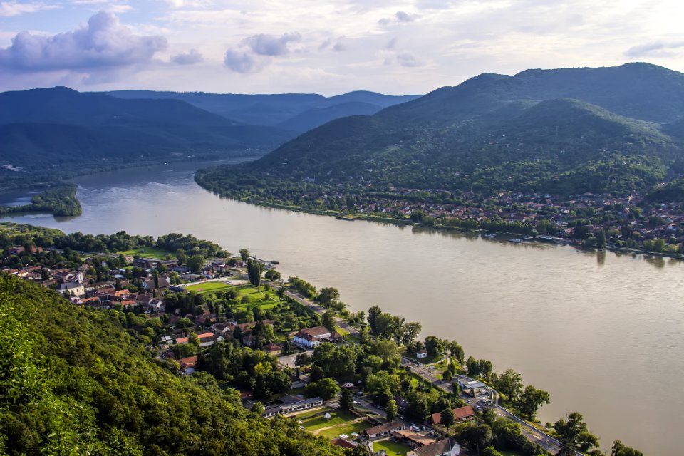 Areal Photo Of Building Across Sea And Mountain During Daytime