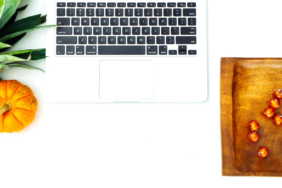 Top View Of Silver Macbook Beside Pumpkin And Brown Wooden Tray