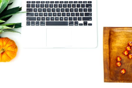 Top View Of Silver Macbook Beside Pumpkin And Brown Wooden Tray photo
