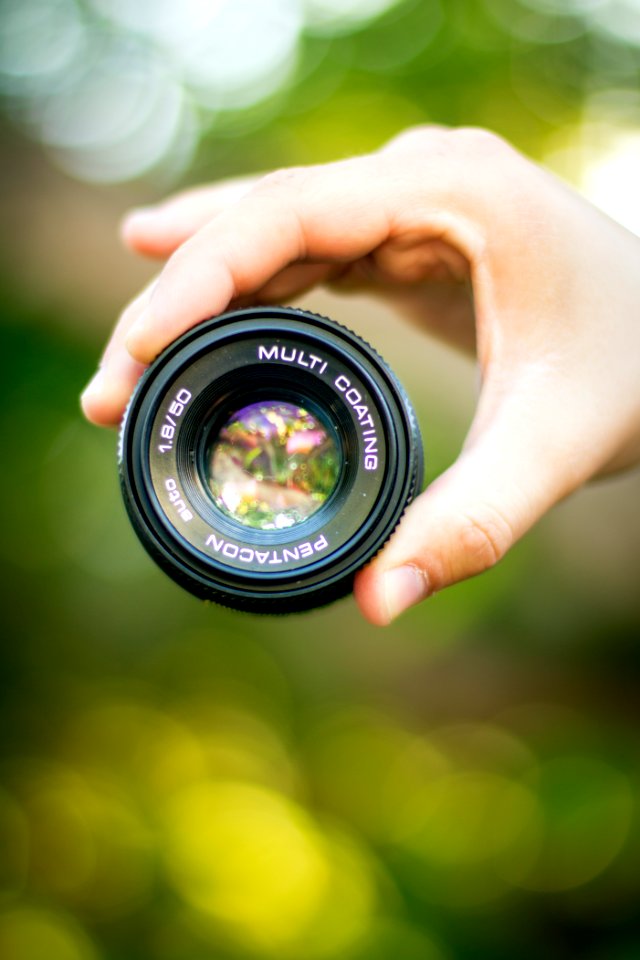 Hand Holding Camera Lens