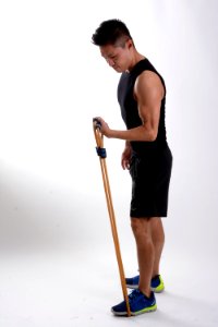 Man In Black Tank Top Holding Brown Stretching Rope