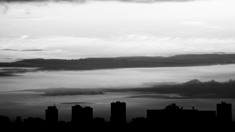 Silhouette Of Buildings Under Gray Clouds photo