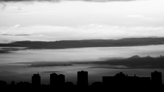 Silhouette Of Buildings Under Gray Clouds photo
