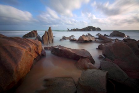 Rocks In Sea During Daytime photo