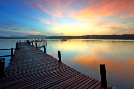Wooden Jetty On Lake At Sunset