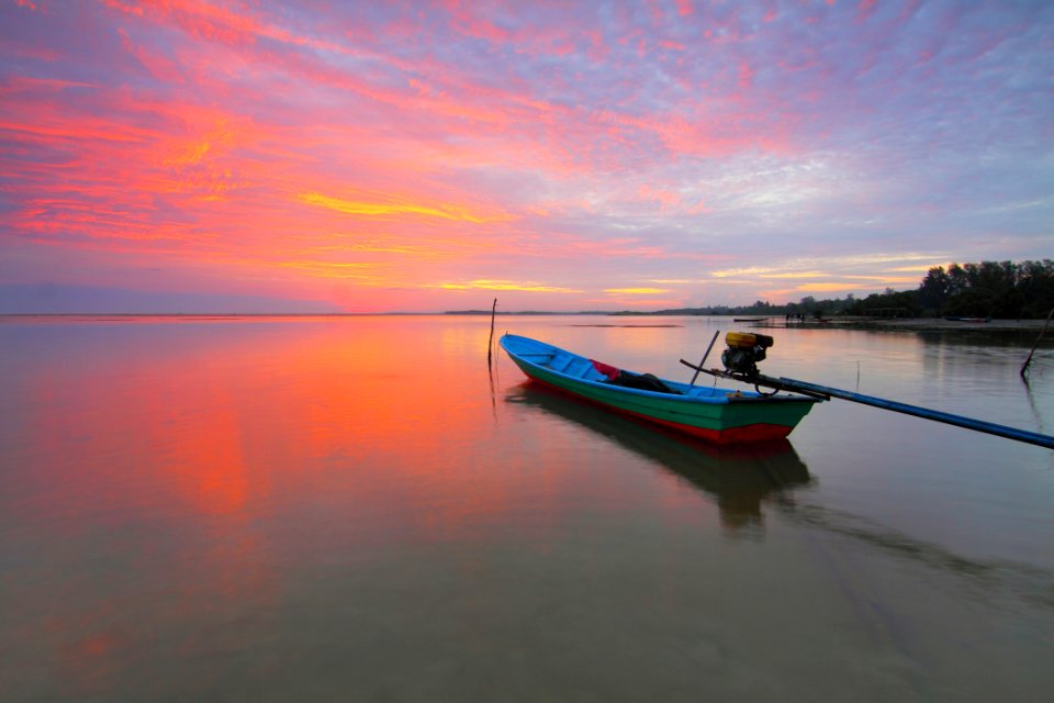 Boat In Sea At Sunset
