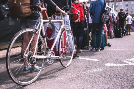 Person In Black Sweater Hold A Grey Road Bike photo