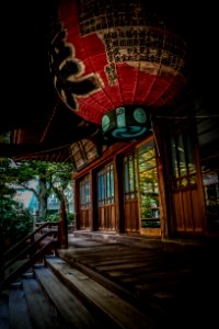 Red Green And Black Floating Lantern With Kanji Text Decoration Above Stairs photo