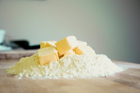 Yellow Pastry On White Powder On Brown Wooden Table
