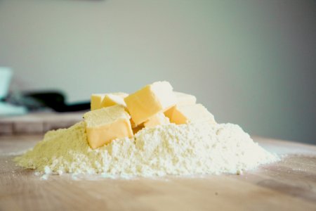 Yellow Pastry On White Powder On Brown Wooden Table photo