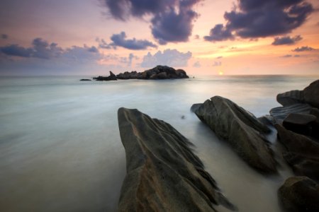 Rock Near A White Foggy Area Under An Orange Sky photo