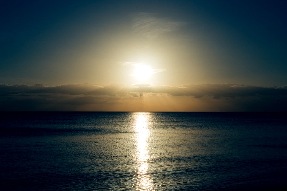 Calm Sea With Sun Setting Photo