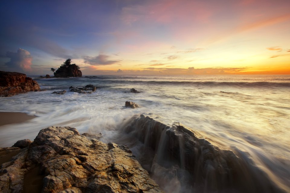 Brown And Grey Rock Near Sea During Sunrise