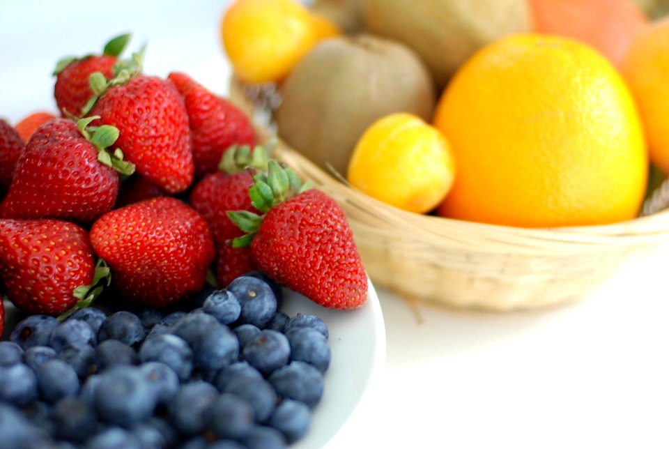 Red Strawberry Blue Berry On White Plate Near Brown Woven Basket