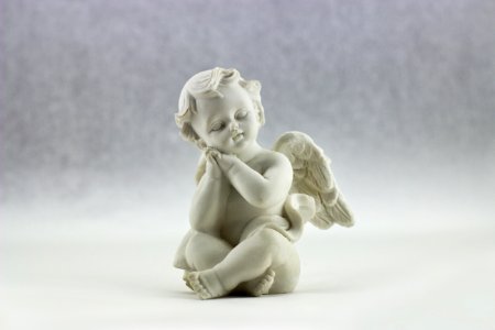 White Ceramic Figurine Of Angel Illustration photo