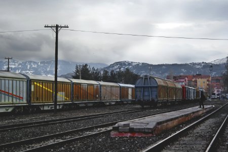 Train Running On Train Track Under Gray Sky At Daytime photo