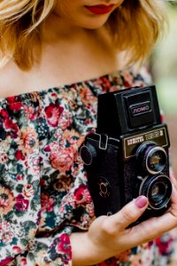 Woman Holding Black Nomo Vintage Camera photo