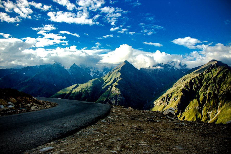 Gray Asphalt Road Near Green Fold Mountain At Daytime photo