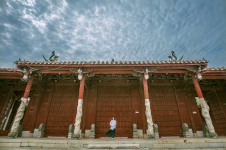 Person Standing Near Red Gate photo