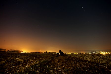 Man On Hillside Over City