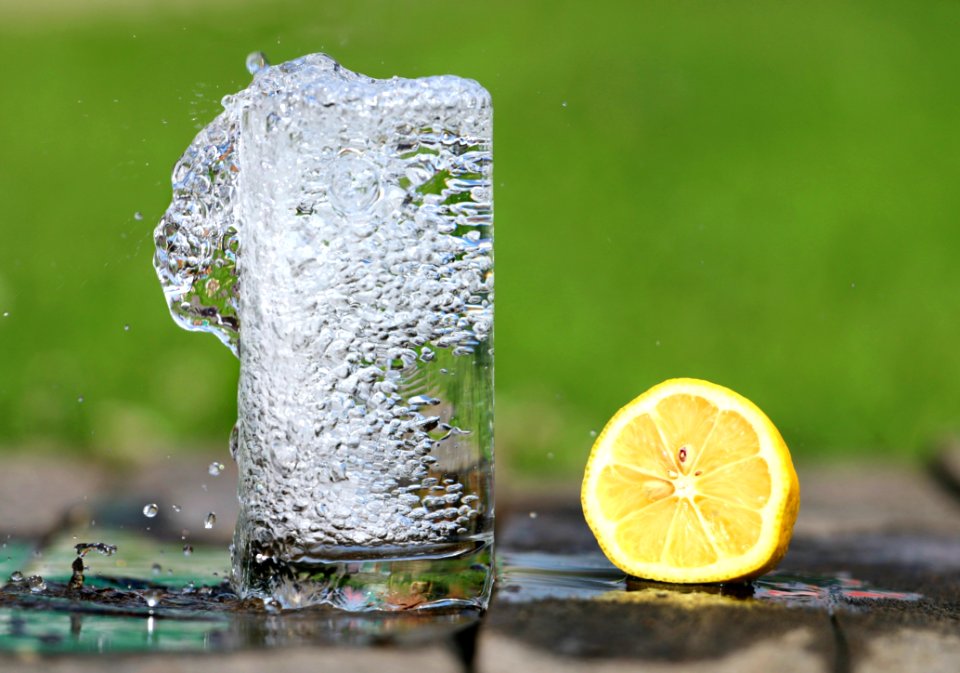 Time Lapse Photography Of Water Bobbling Beside Lemon Fruit