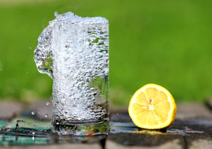 Time Lapse Photography Of Water Bobbling Beside Lemon Fruit photo