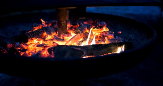 Round Fire Pit With Burning Wood photo