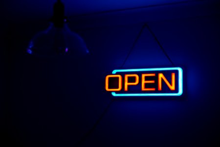 Yellow And Teal Open Neon Signage photo