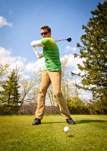 Man In Green And White Stripes Long Sleeve Shirt Holding Black Golf Club