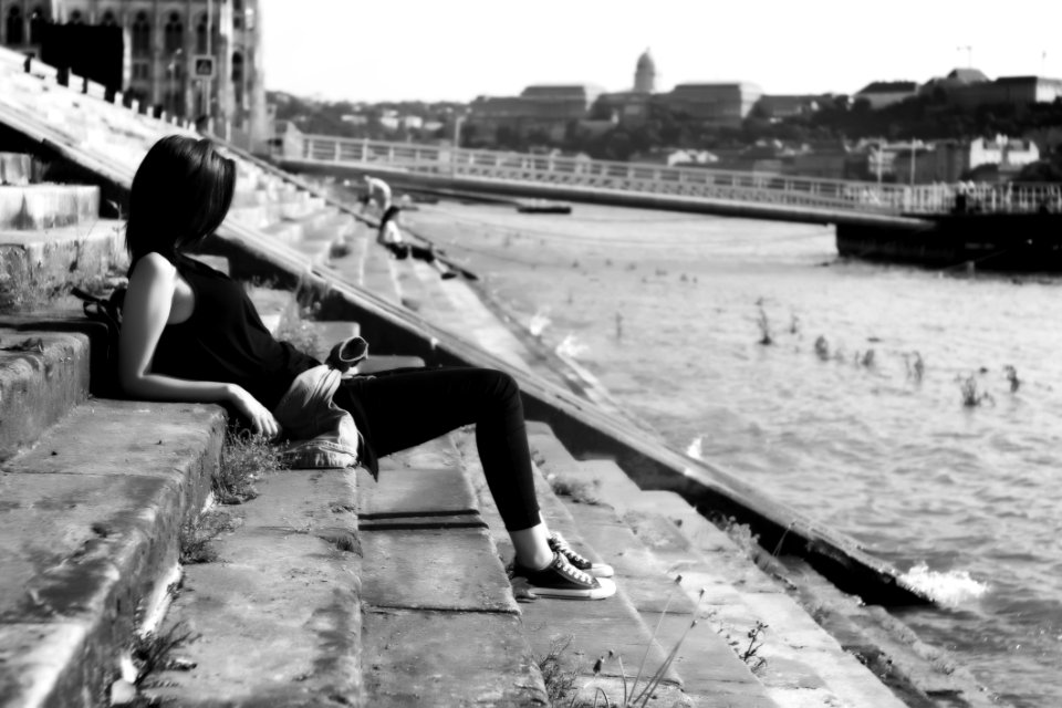 Woman On Black Shirt Sitting On Stairs In Front Of River