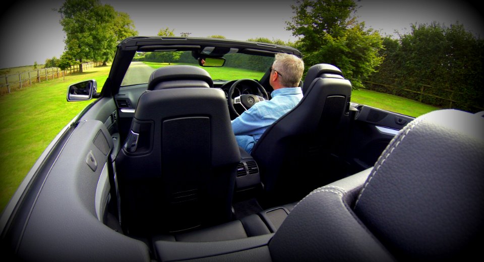 Man In Blue Dress Shirt Driving Convertible Car During Daytime