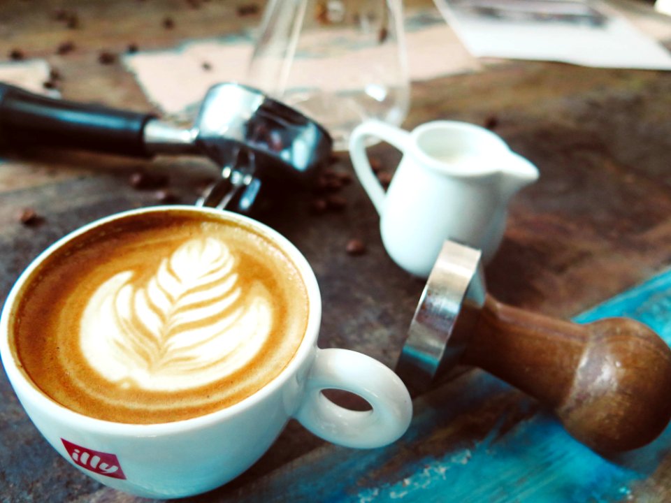 Latte On Cup Beside Milk Cup