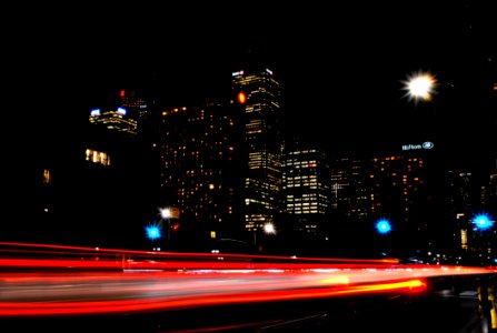 Time Lapse Photography Of Red And Orange Taillight In City During Daytime photo