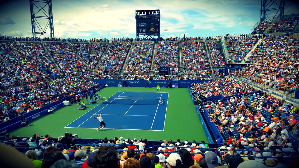 People Sitting On Bench Watching Tennis Event On Field During Daytime photo