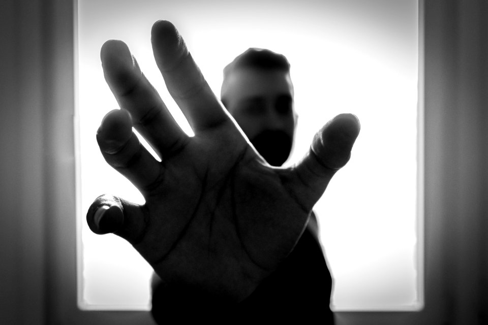 Grayscale Photo Of Man Grabbing Using Right Hand photo