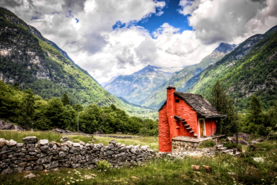 Brick House With Chimney In The Middle Of Green Fields During Cloudy Day Photo