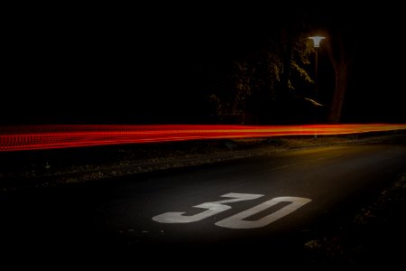 Time Lapse Photography Of Red And Orange Light On Road With 30 Print On Nighttime