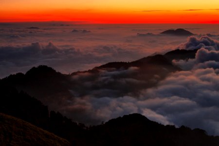 High View Photography Of Mountain Ranges Surrounded With Clouds At Golden Hour