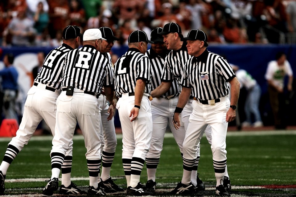 8 Football Referees In The Field