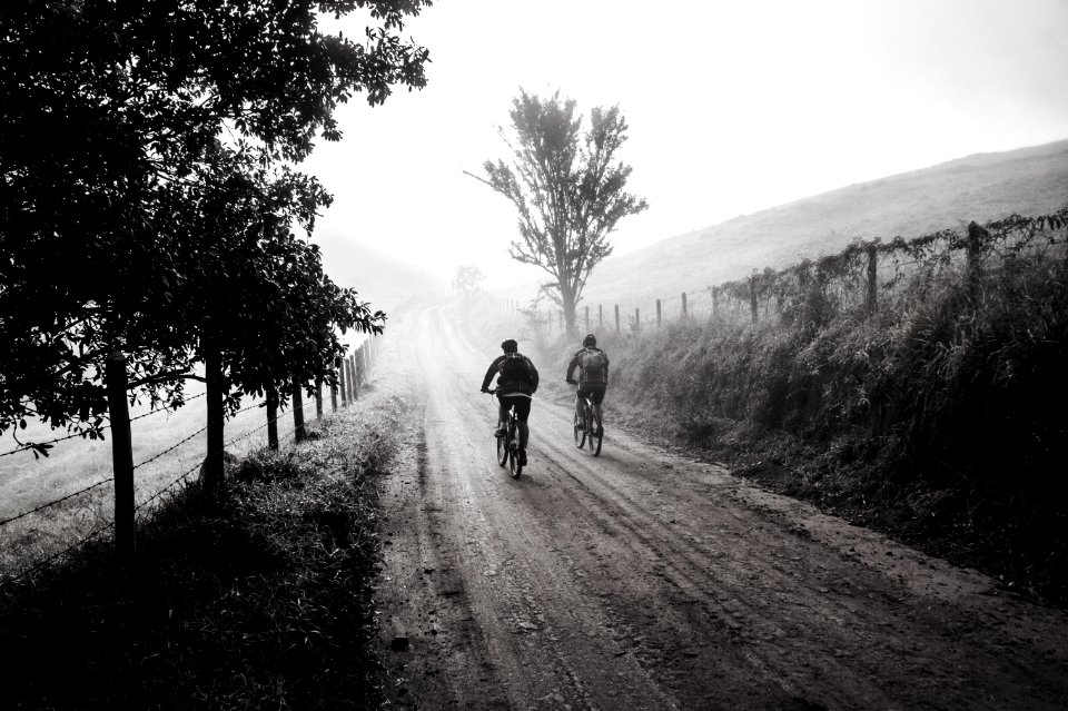 Grayscale Photography Of Two Person Biking