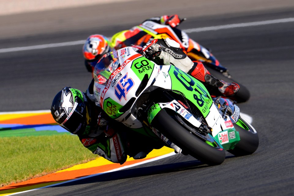 Two Motorcycle Racers Turning At Corner