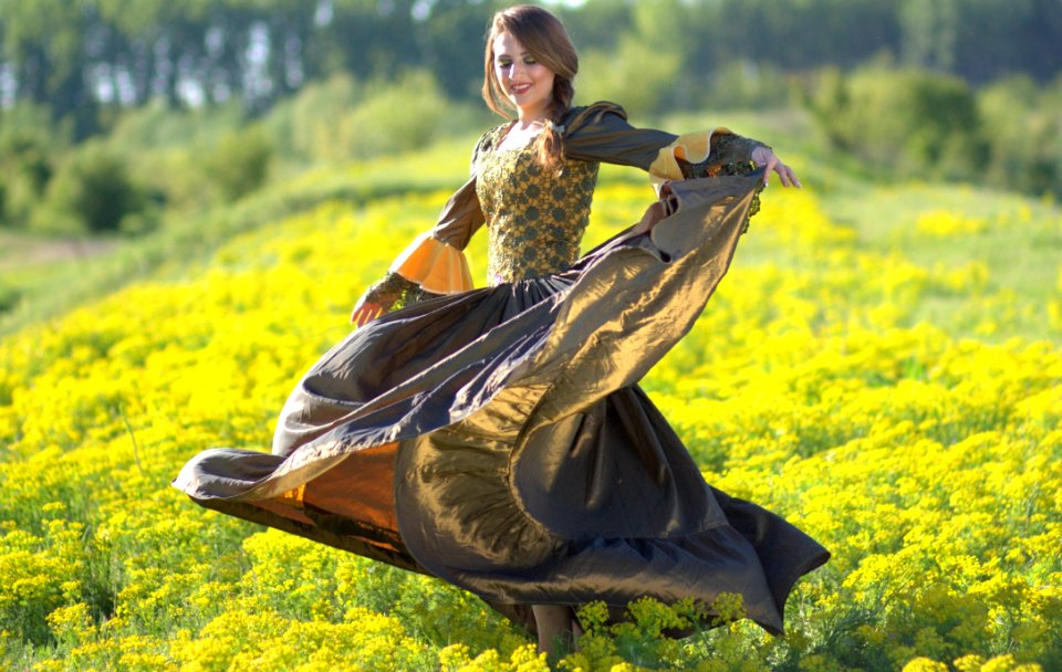 Woman On Princess Costume Waving Her Dress On Green Flower Fields
