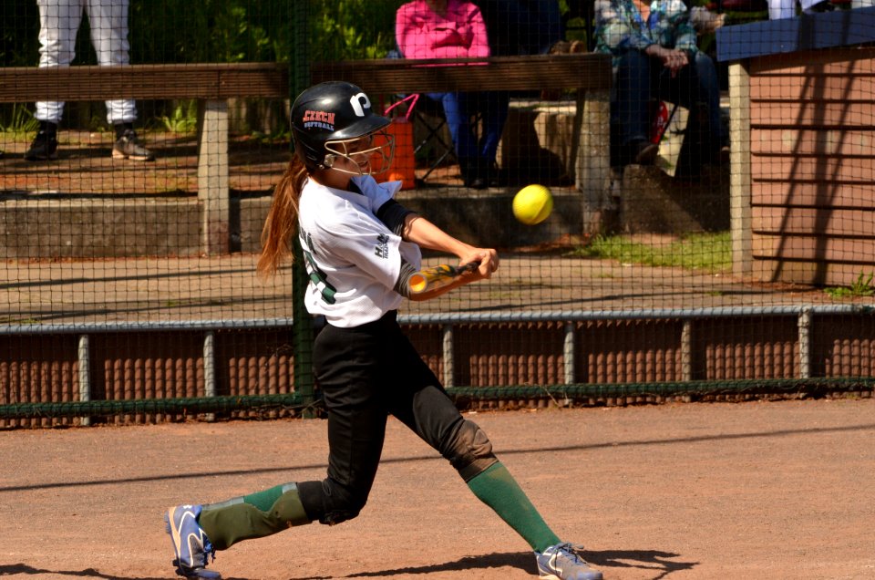 Woman Baseball Player Holding Brown Bat