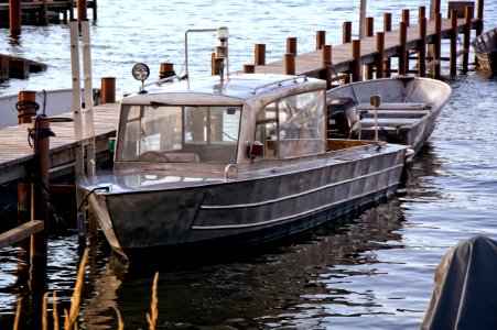 Product Photography Of Silver Motor Boat Neck Dock During Daytime photo
